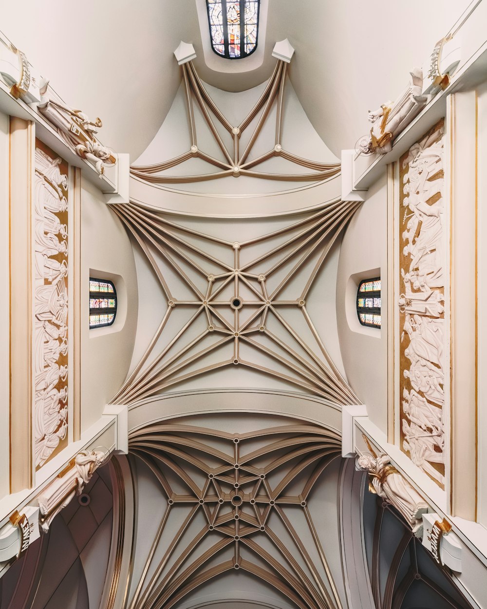 the ceiling of a church with a stained glass window