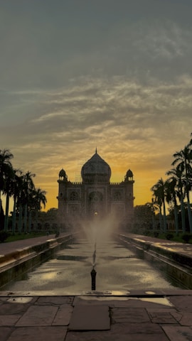 Sunset over an iconic Indian monument with warm, glowing skies.