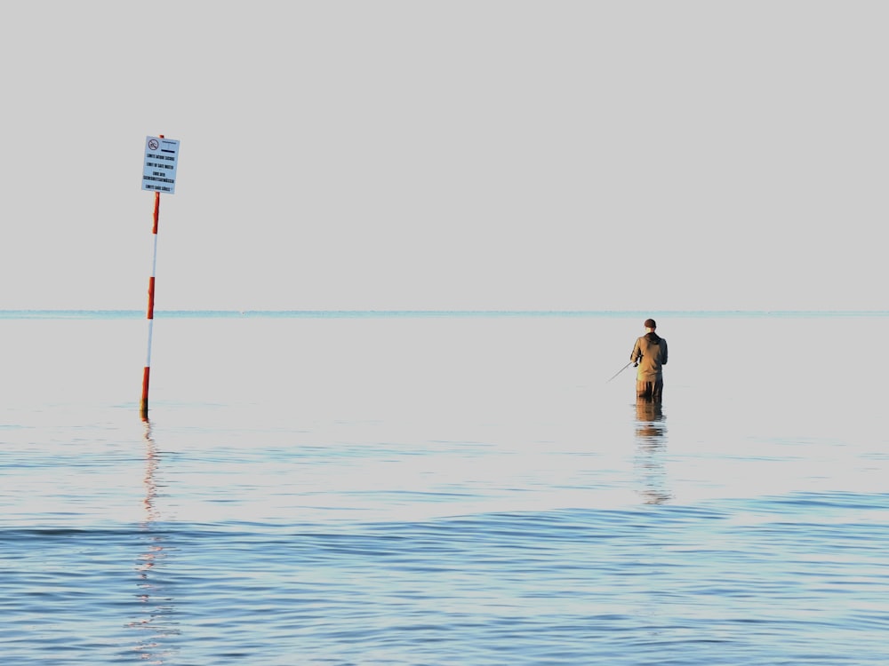 a man standing in the middle of a body of water