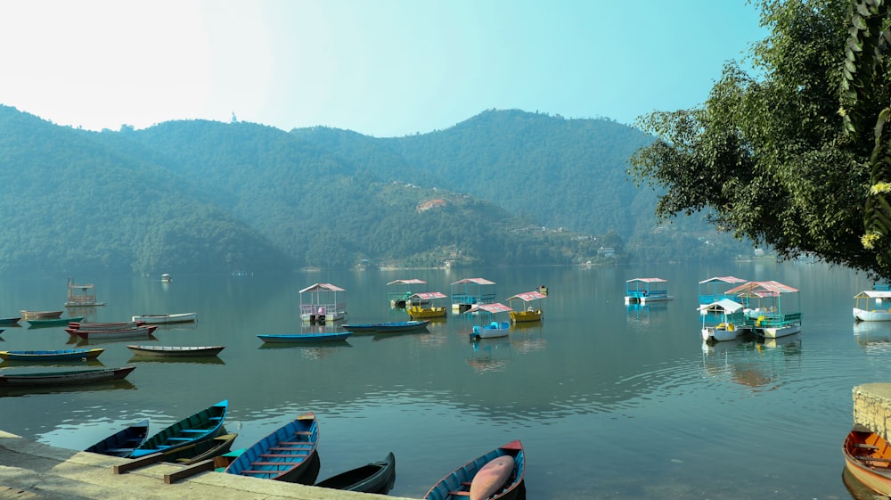 a group of boats floating on top of a lake