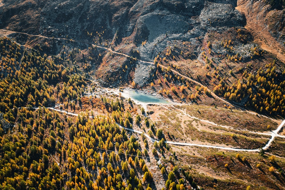 an aerial view of a mountain with a river in the middle