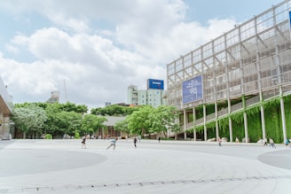 A vibrant urban plaza with integrated greenery and pedestrian pathways in Kobe city.