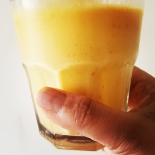 Hands carefully pouring kefir into a glass, showing creamy texture and freshness.