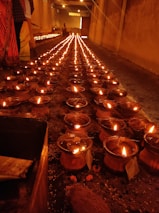 Evening aarti ceremony with lamps glowing warmly in the temple hall.
