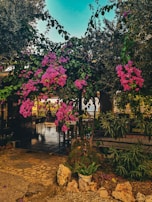 A peaceful seating area surrounded by flowering plants.
