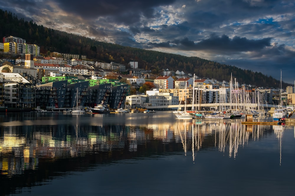 a harbor filled with lots of boats under a cloudy sky