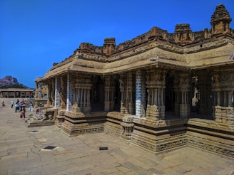 A group photo in front of an ancient spiritual monument under a clear blue sky.