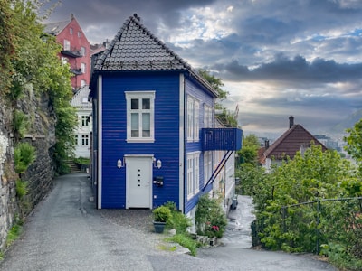 A vibrant exterior house wall in bright blue under a sunny sky