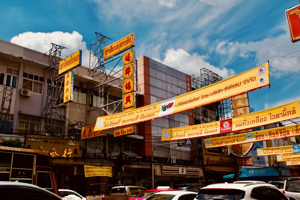 a bunch of signs hanging from the side of a building