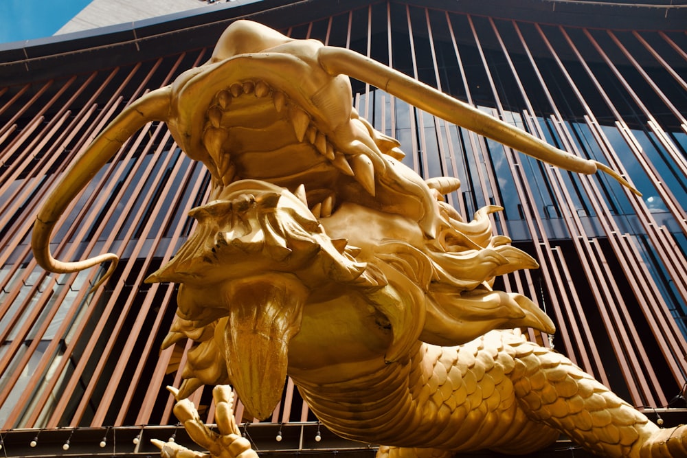 a statue of a dragon on the side of a building