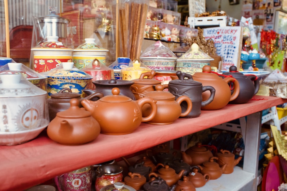 a red table topped with lots of pots and pans