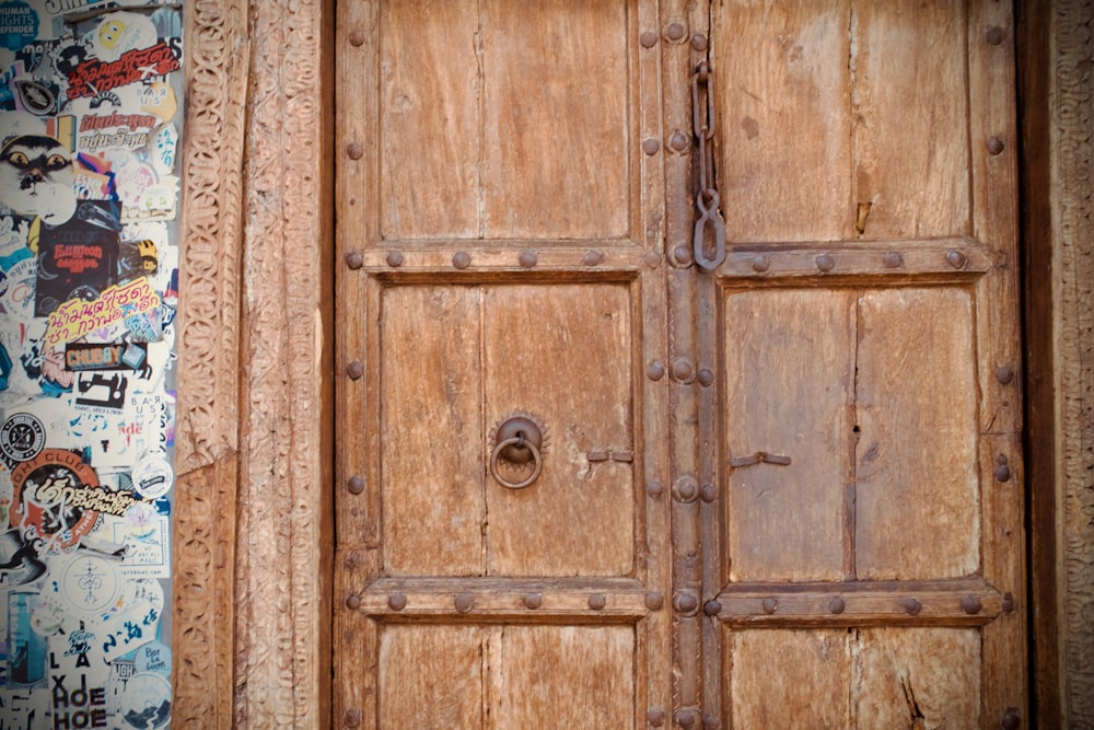 a wooden door with a bunch of stickers on it