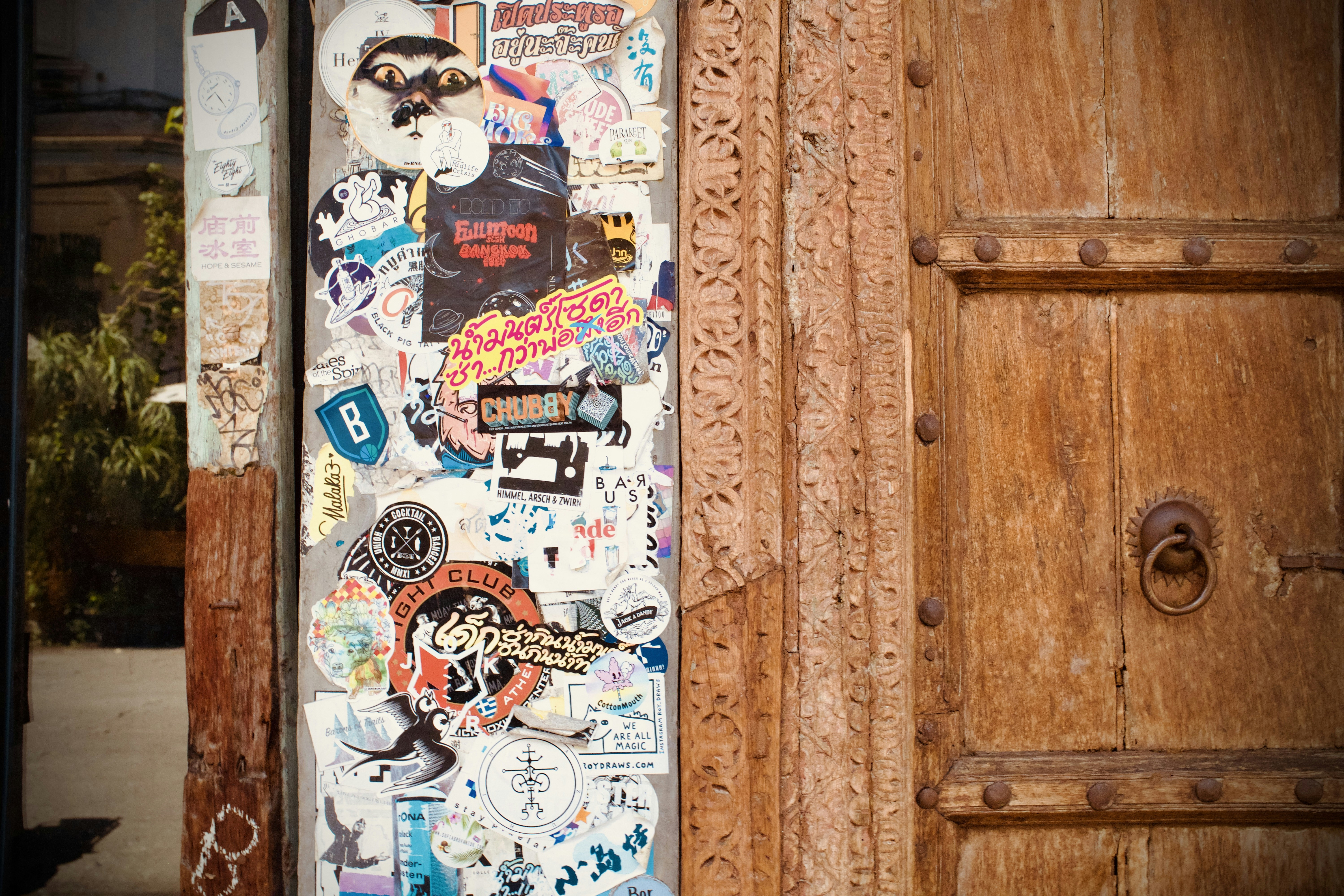 a wooden door with a bunch of stickers on it