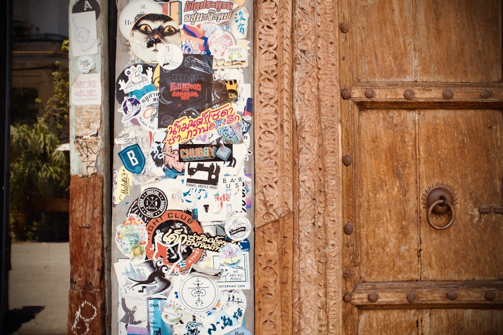 a wooden door with a bunch of stickers on it