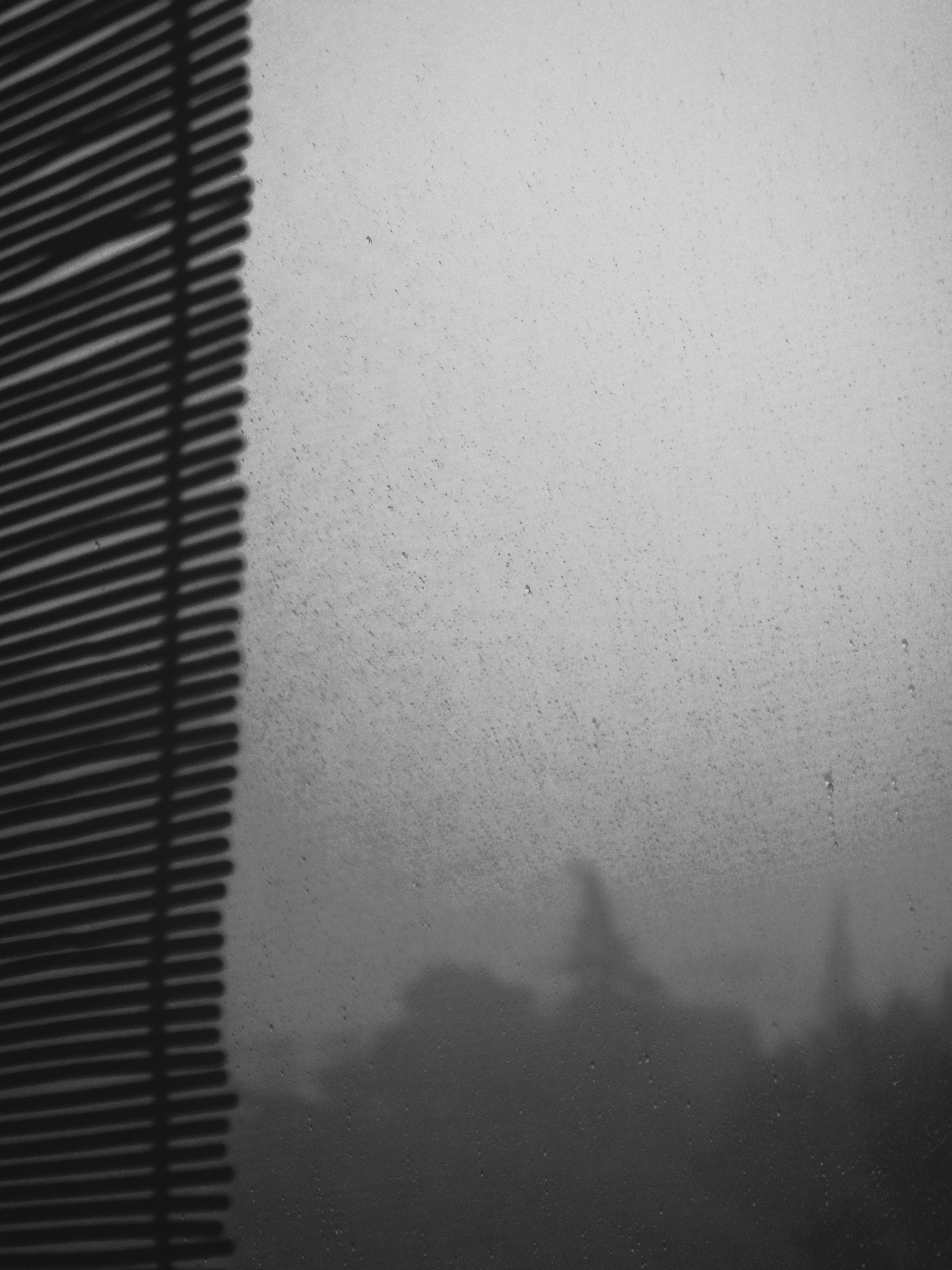 uma foto em preto e branco de um prédio e uma janela