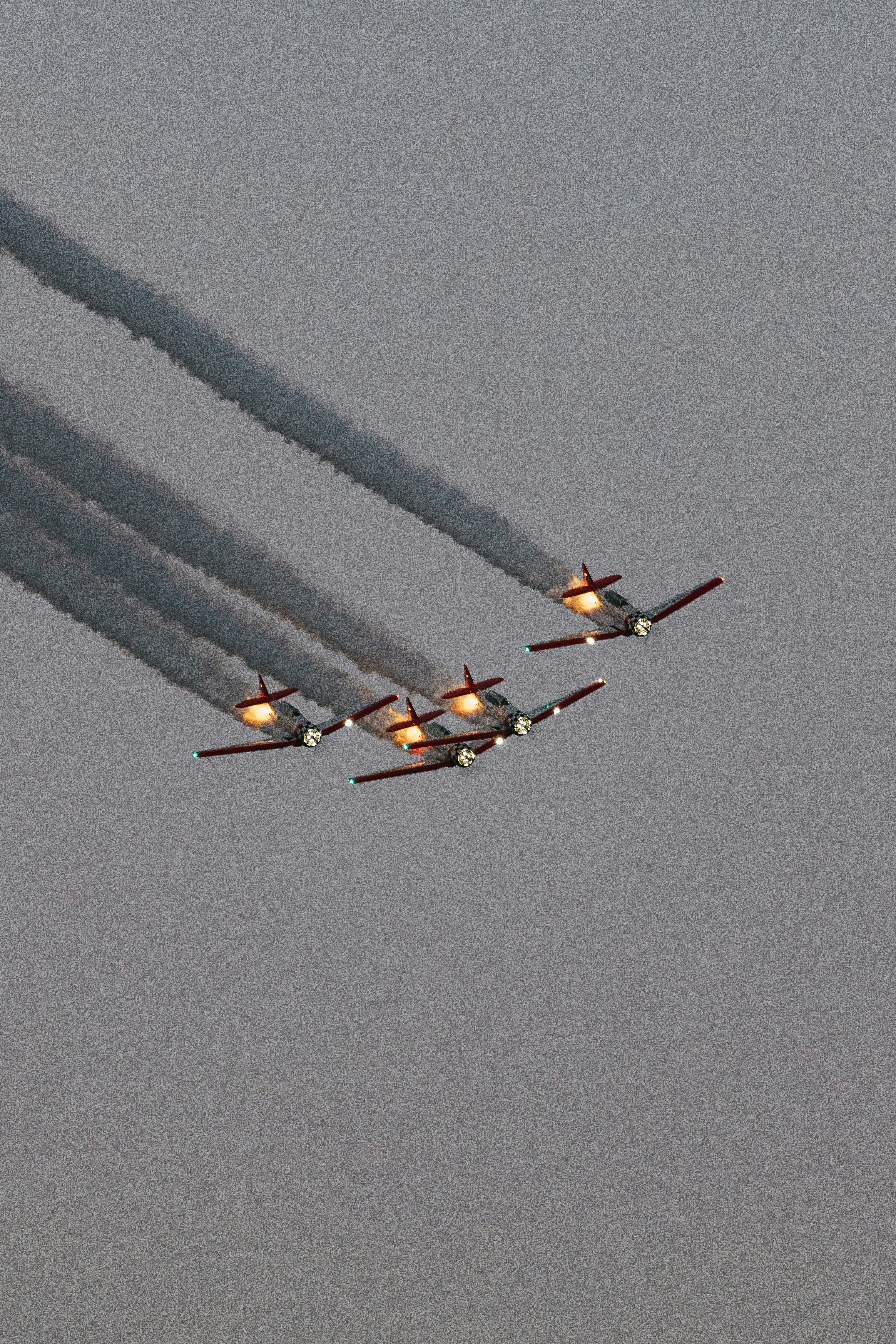 a group of airplanes flying through a cloudy sky