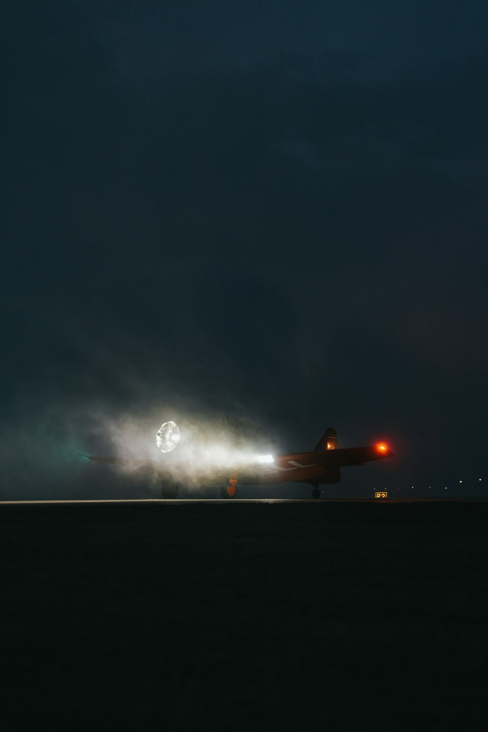 a plane that is on a runway at night