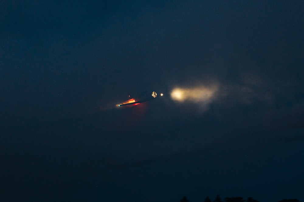 a plane is flying in the sky at night