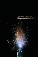 a fireworks is lit up in the dark sky