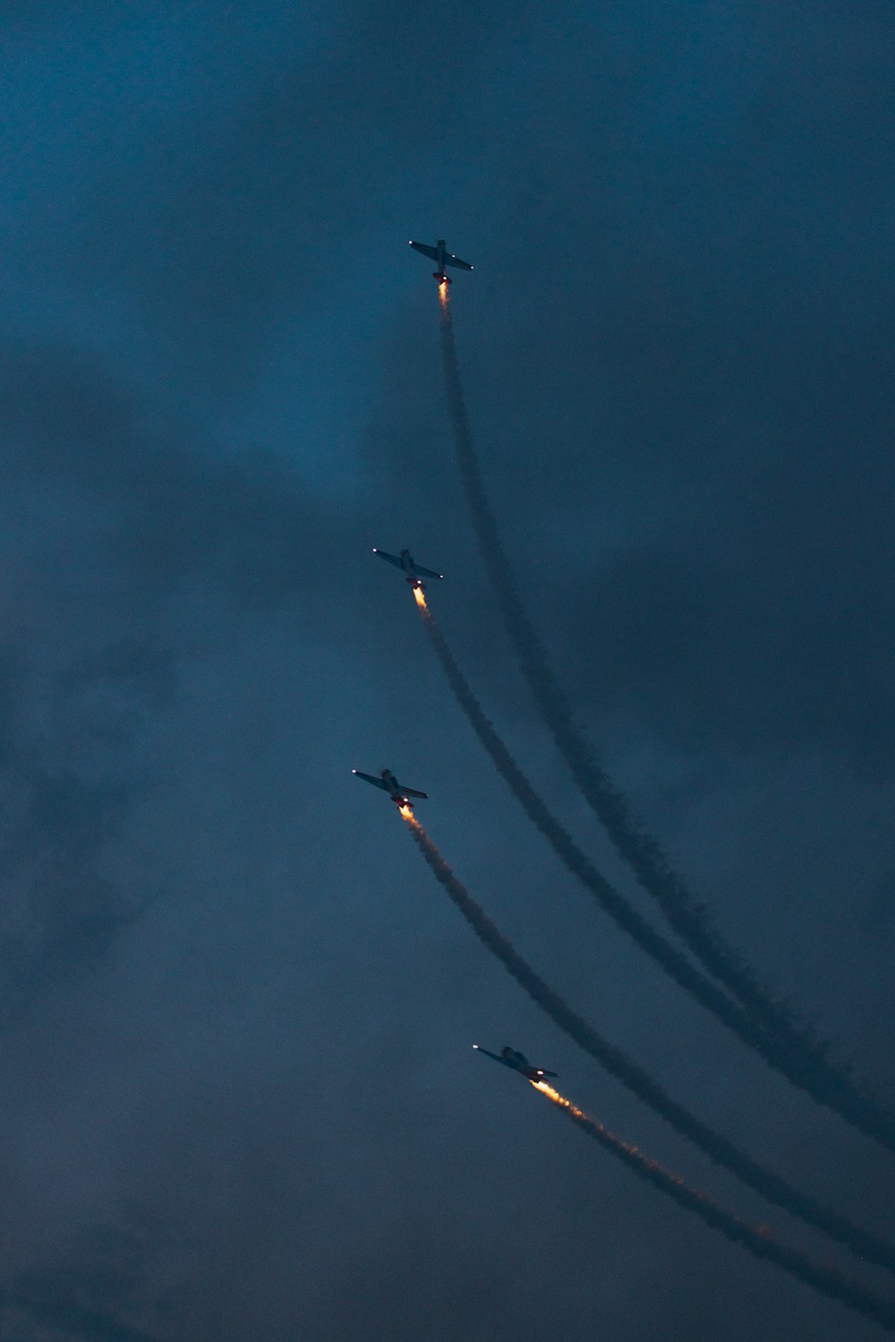 a group of airplanes flying through a cloudy sky