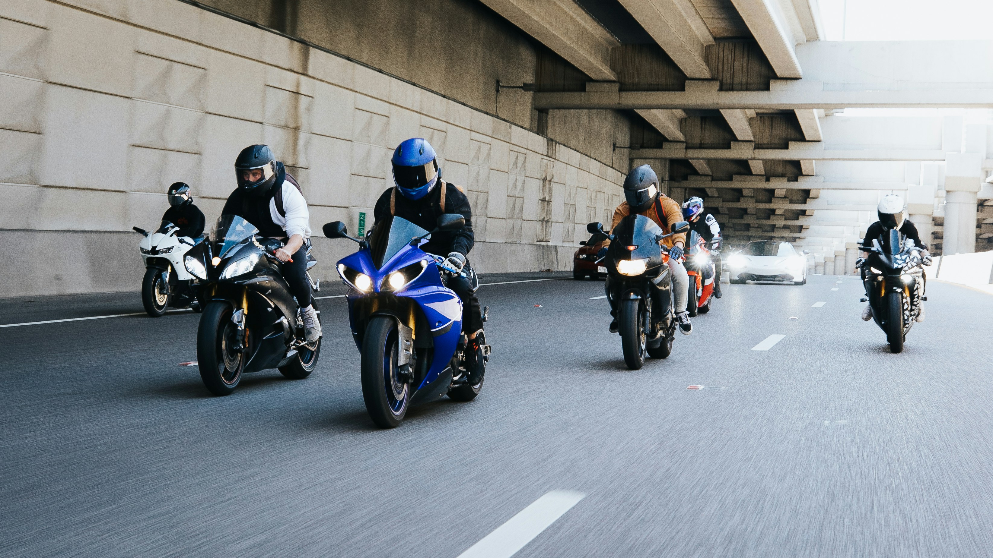 a group of people riding motorcycles down a street
