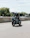 Happy woman riding a new motorcycle on a sunny day