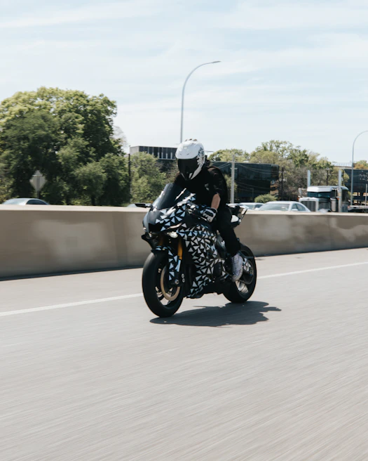 Action shot of a biker wearing Fortiguard armored jacket on a sunny street