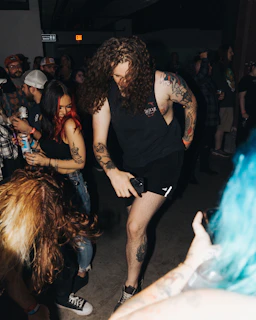 A vibrant community event showcasing tattoo art and cultural expressions in a lively setting.