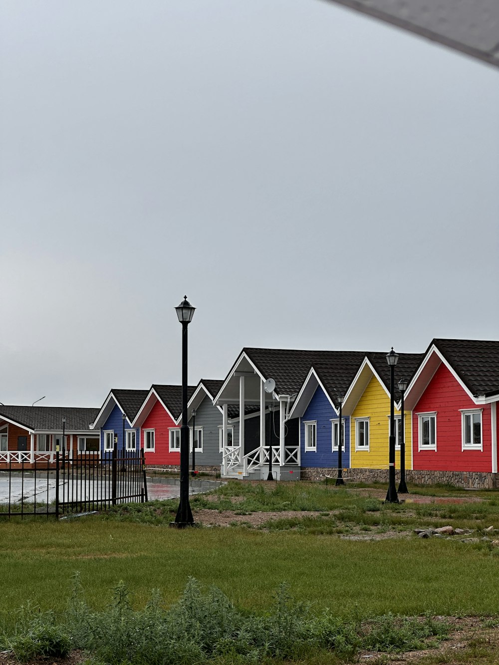 a row of colorful houses next to a street light