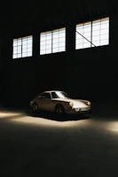 A classic vintage car displayed in a rustic garage setting.