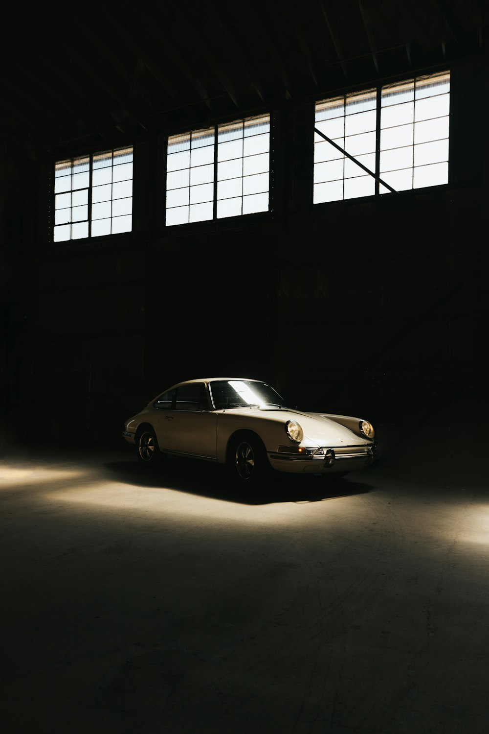 a car is parked in a dimly lit garage
