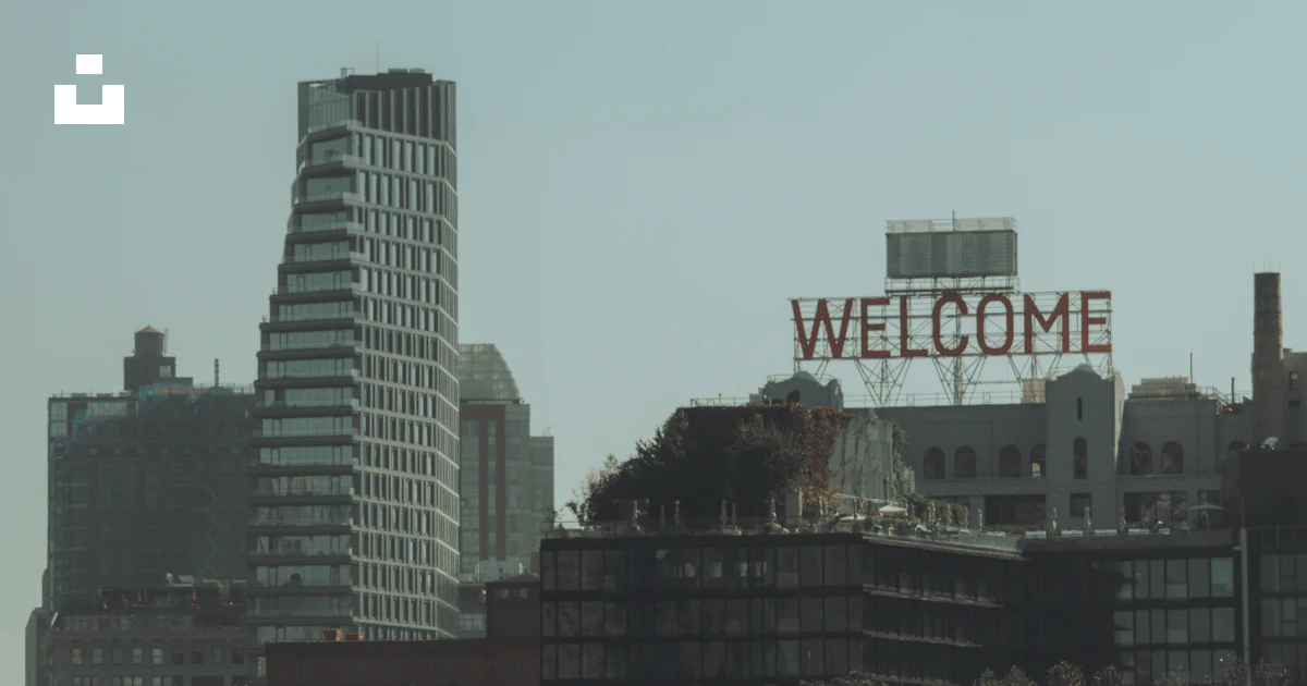A large welcome sign on top of a building photo – Free Building Image ...
