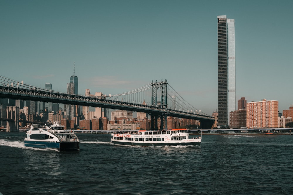 a boat traveling under a bridge in a body of water