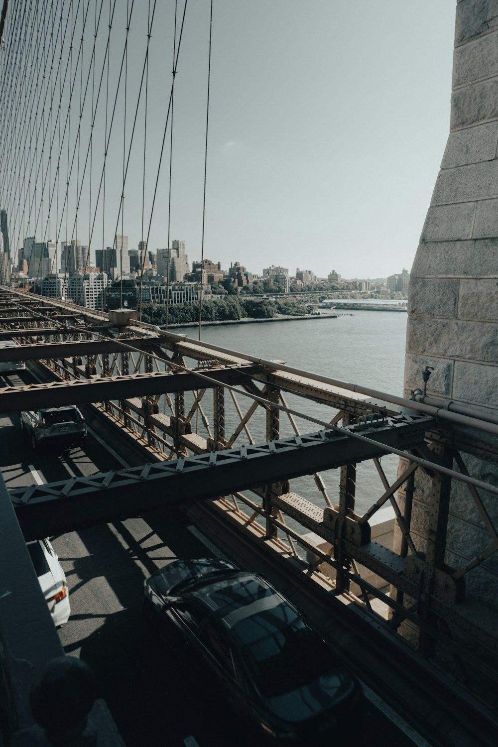 cars are driving on a bridge over a body of water