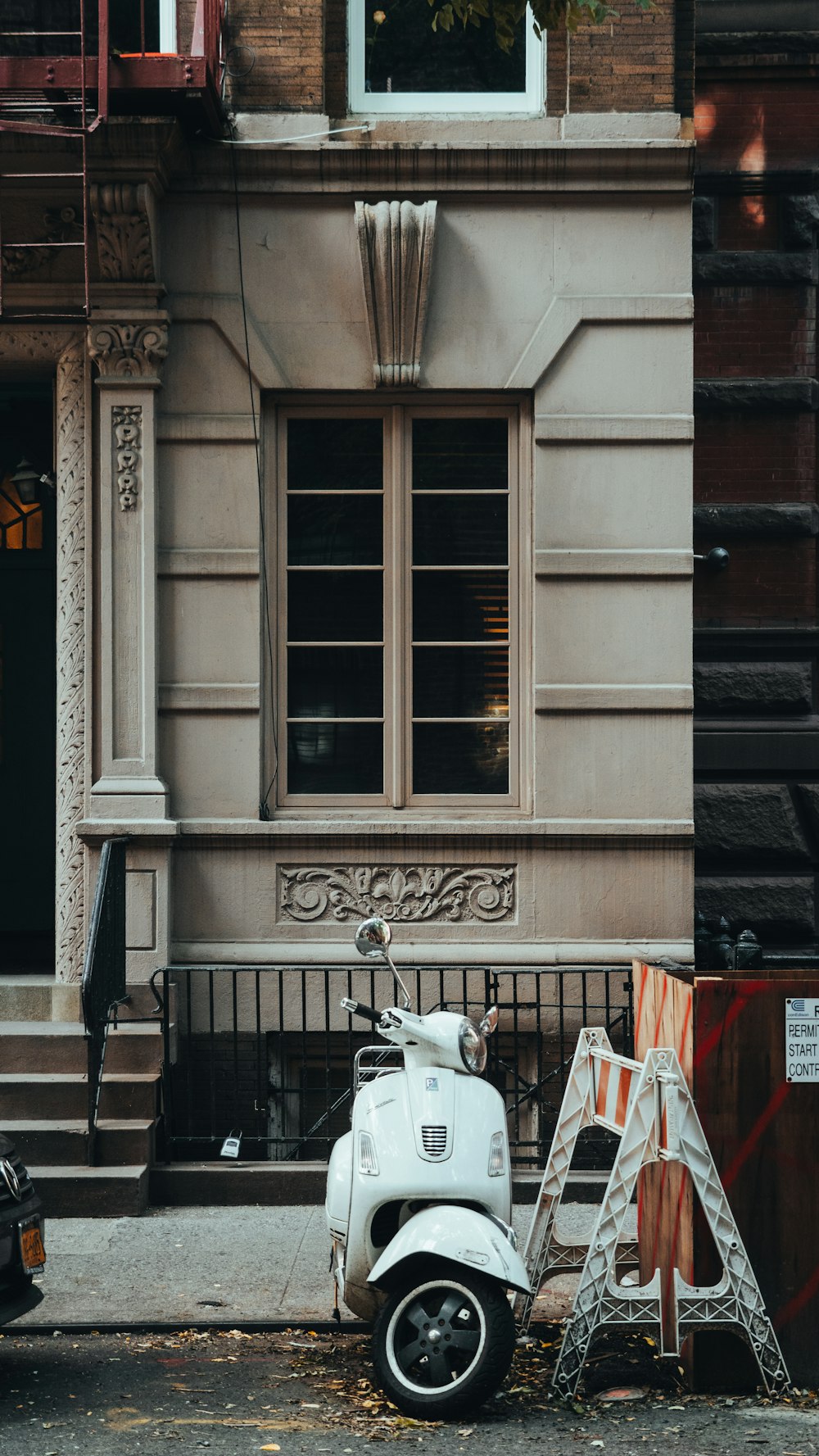 a scooter is parked in front of a building