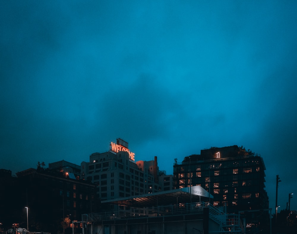 a city skyline at night with a building lit up