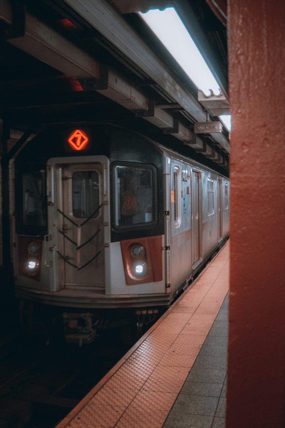 a subway train pulling into a train station