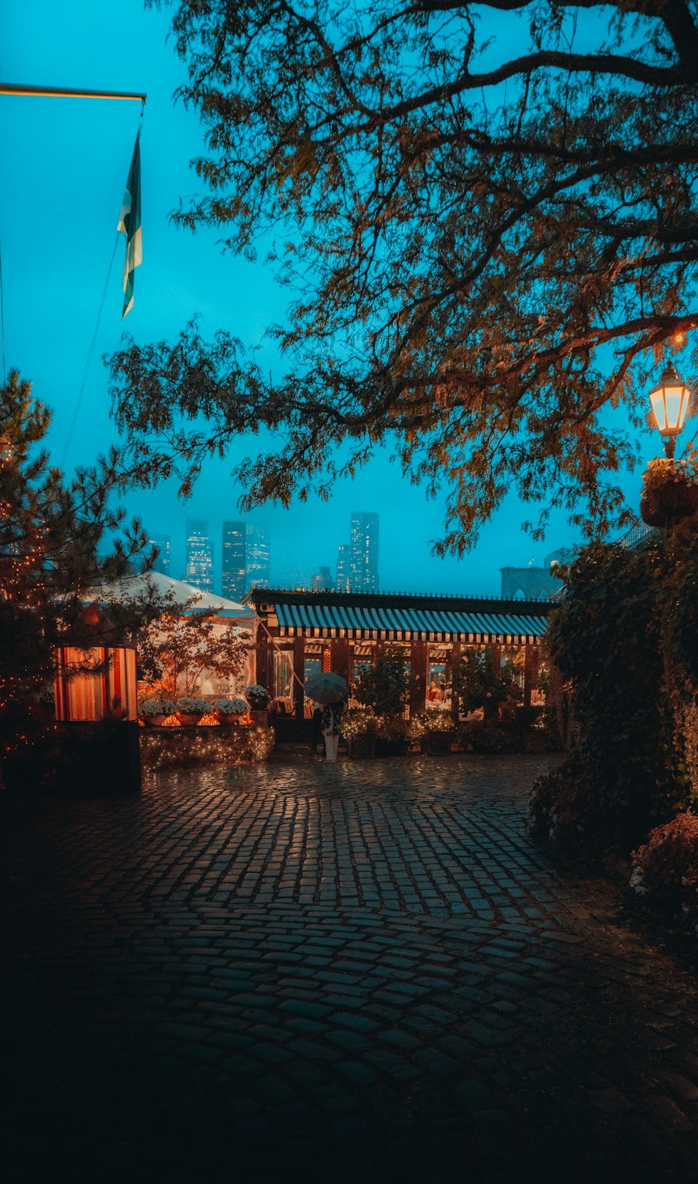 a cobblestone walkway with a building in the background