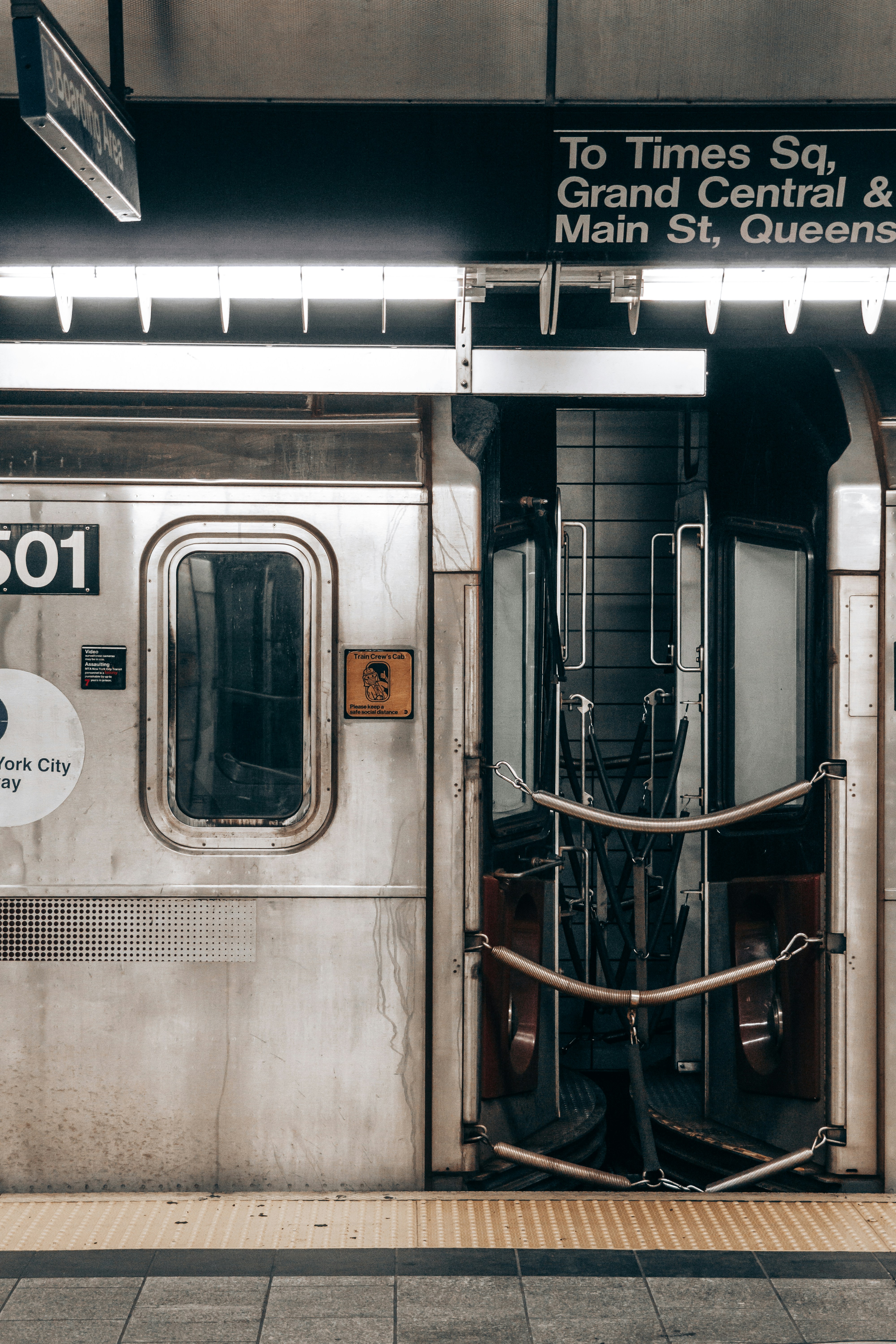 a subway car with its doors open at the station