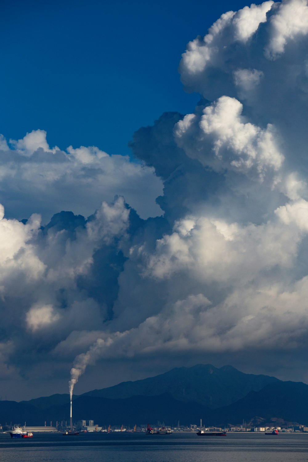 a large plume of smoke coming out of a chimney