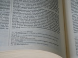 An open book with visible text on both left and right pages. The text is formatted in columns, containing both headings and footnotes. The page numbers and chapters are visible, showcasing detailed content likely from a non-fiction genre.