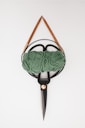 a pair of scissors and a ball of yarn on a hook
