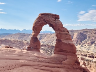 a large rock formation in the middle of a desert
