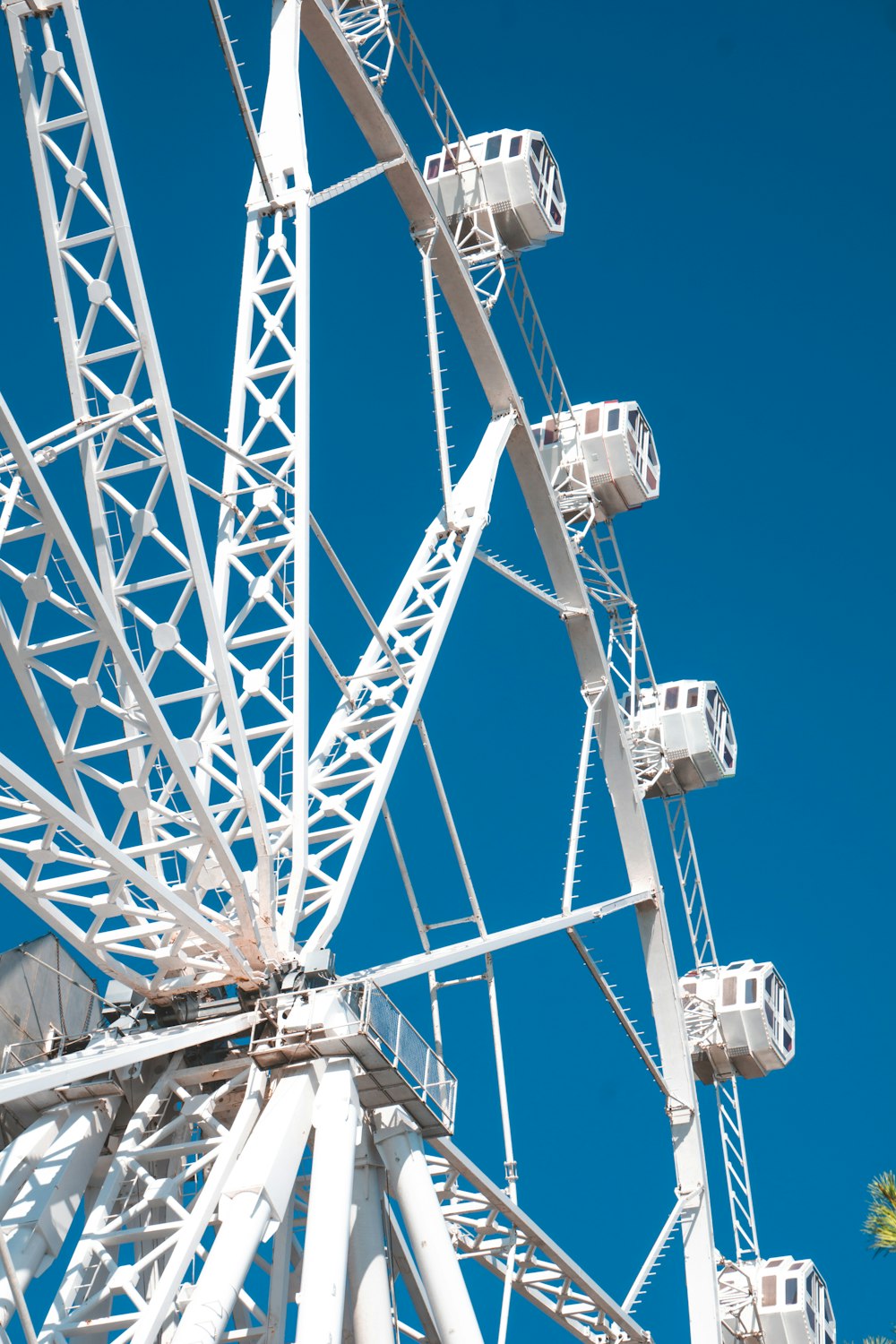 a white ferris wheel against a blue sky