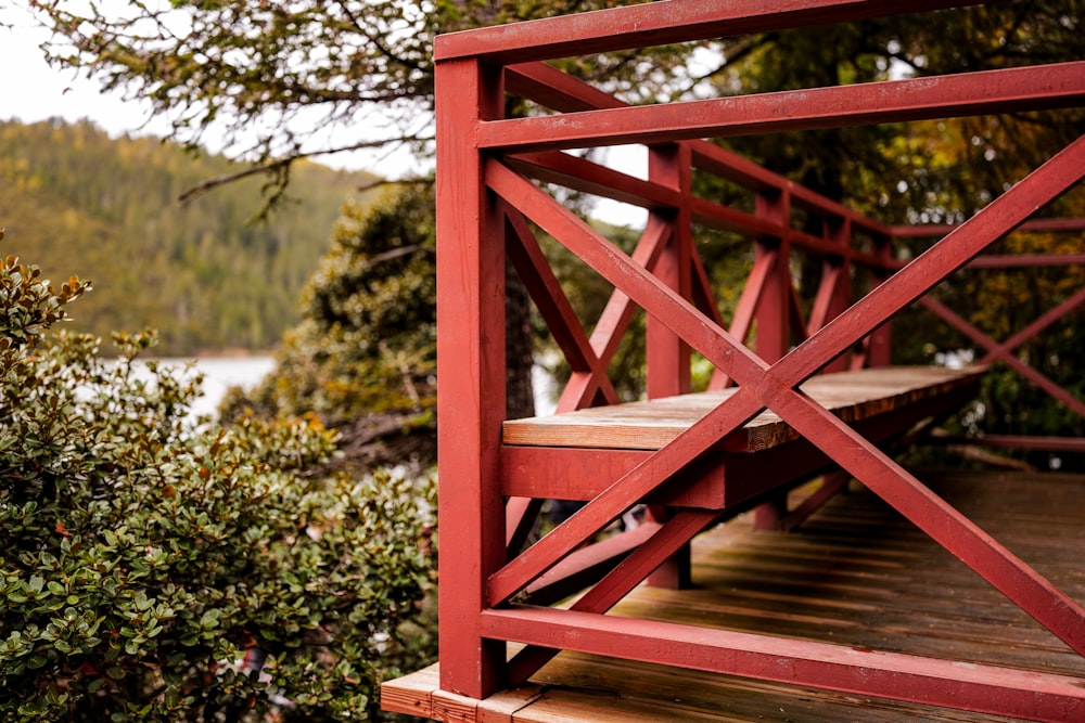 a red wooden bridge over a body of water