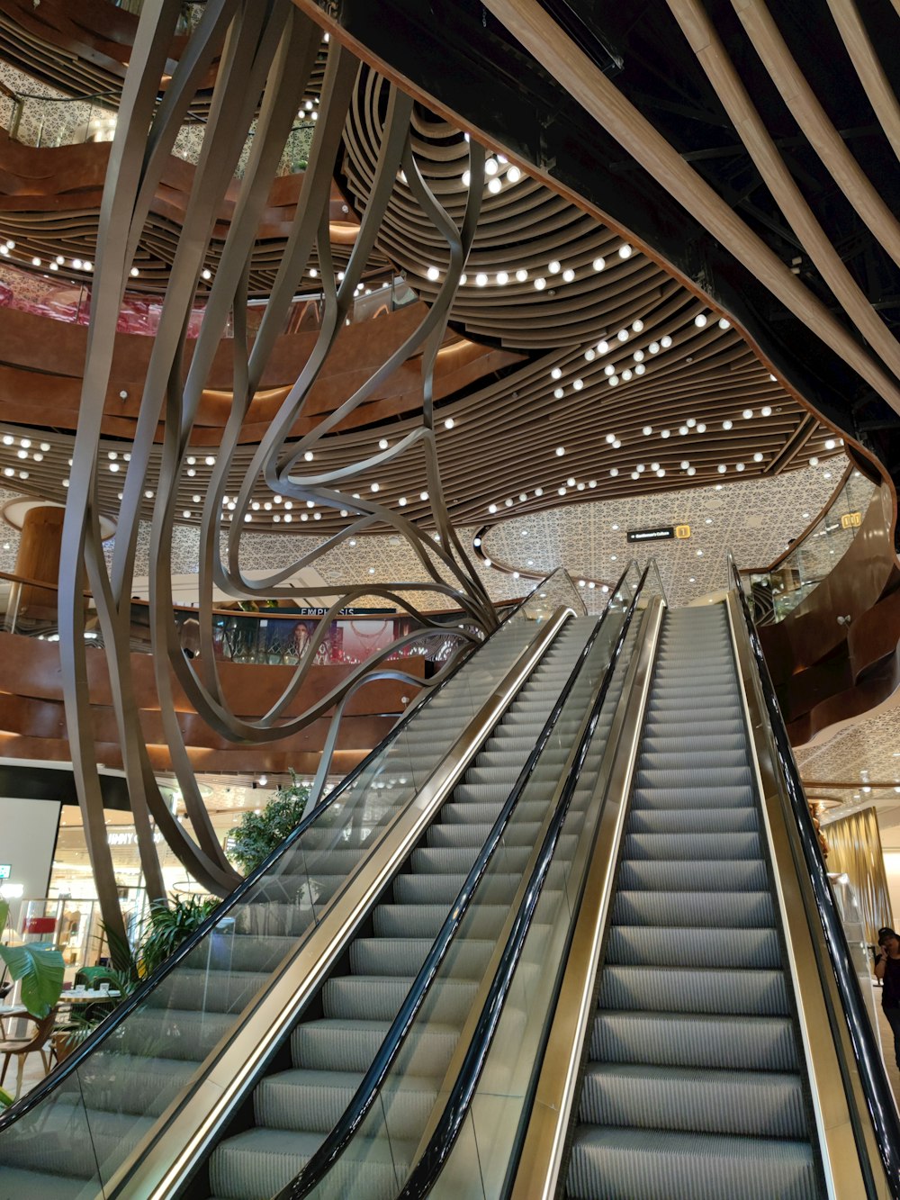 an escalator in a building with a bunch of lights