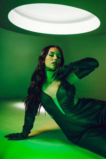 A powerful, sleek black-themed image showing a confident woman working with futuristic technology interfaces.