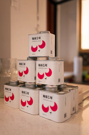 Rows of finished food-grade metal cans stacked neatly, ready for shipment.