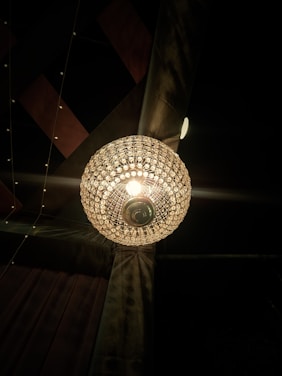 A stunning sculptural chandelier casting soft, inviting light over a modern living room.