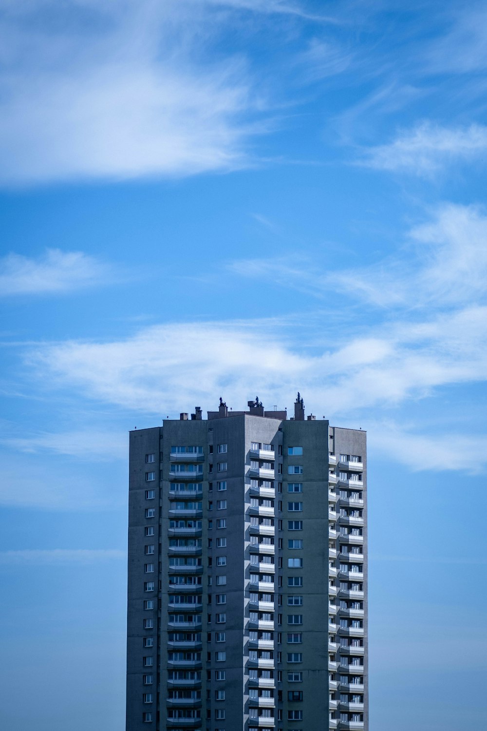 a very tall building sitting next to a body of water